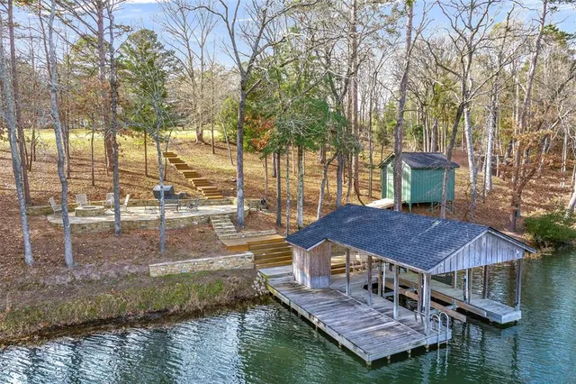 a aerial view of a house with a yard and lake view