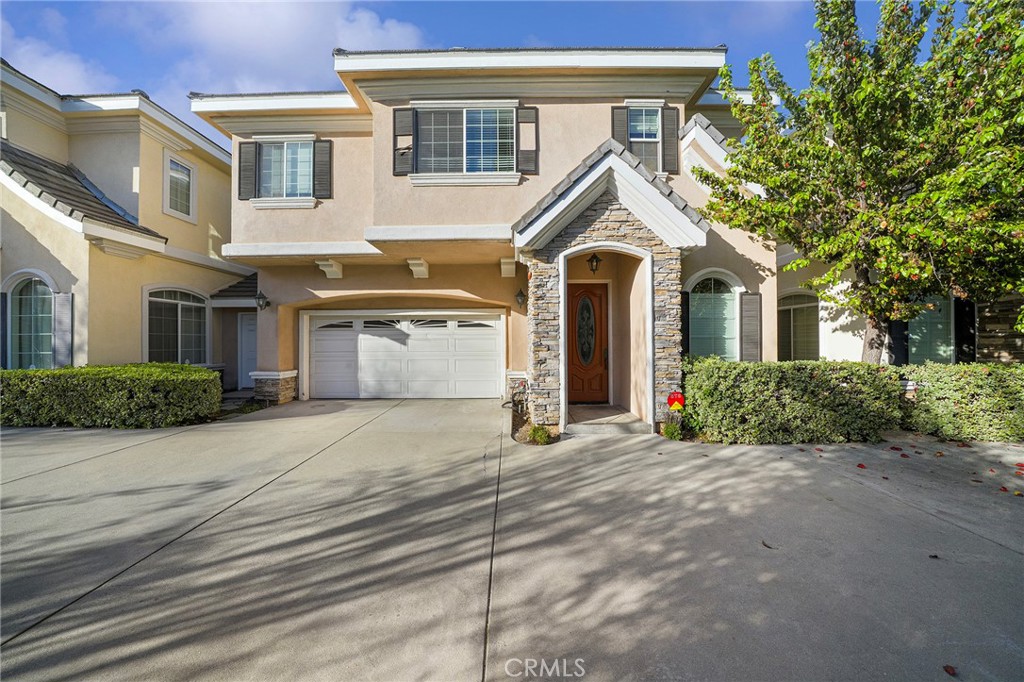 527 Fifth Avenue, Unit B Arcadia, CA 91006 - Photo 1 of 33 a view of a white house with large windows and a small yard