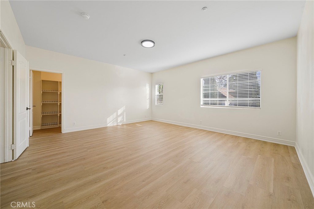 527 Fifth Avenue, Unit B Arcadia, CA 91006 - Photo 18 of 33 a view of an empty room with wooden floor and a window