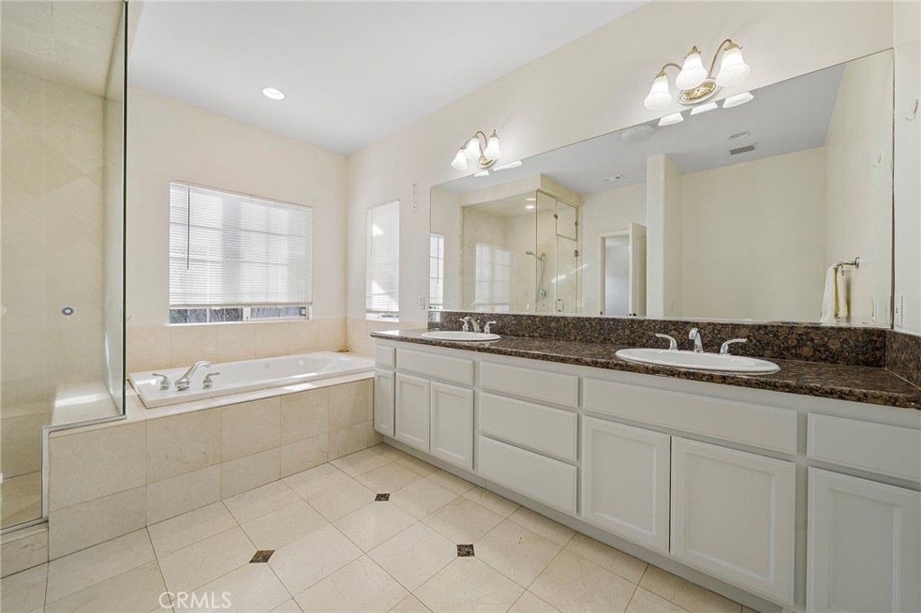 527 Fifth Avenue, Unit B Arcadia, CA 91006 - Photo 20 of 33 a spacious bathroom with a granite countertop tub a double vanity sink a vanity and a large mirror