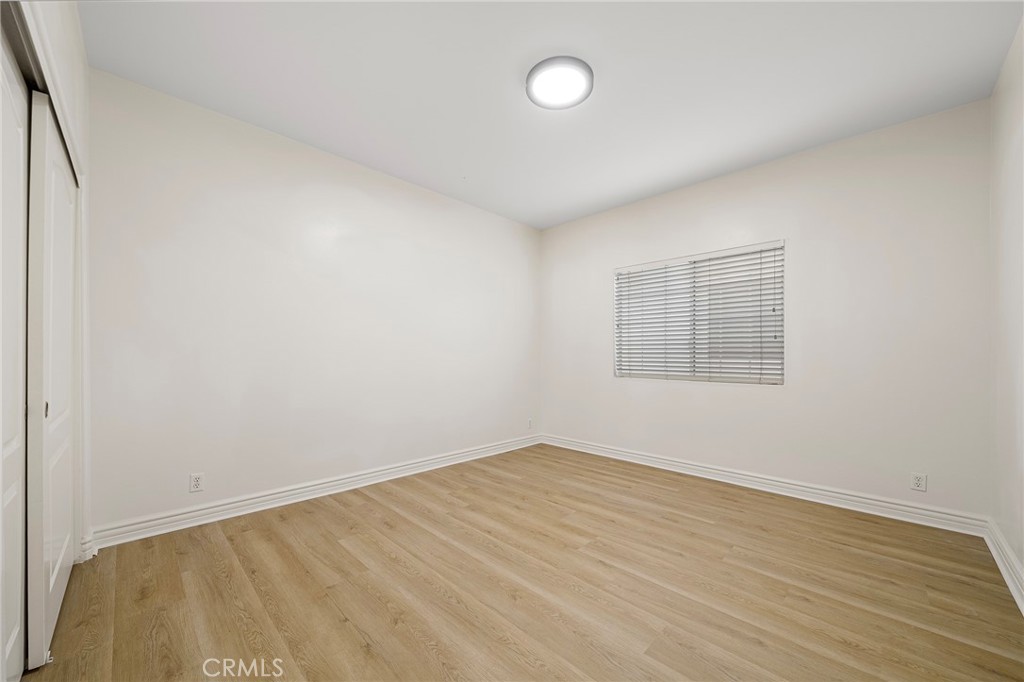 527 Fifth Avenue, Unit B Arcadia, CA 91006 - Photo 23 of 33 an empty room with wooden floor and windows