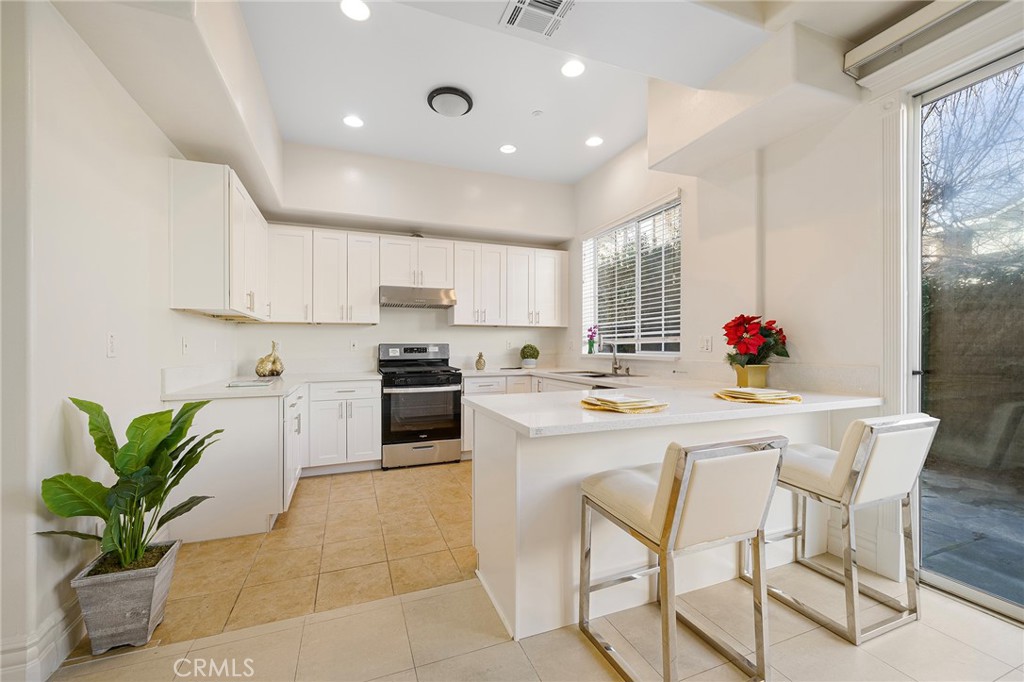 527 Fifth Avenue, Unit B Arcadia, CA 91006 - Photo 9 of 33 a kitchen with stainless steel appliances kitchen island granite countertop a refrigerator and a stove top oven