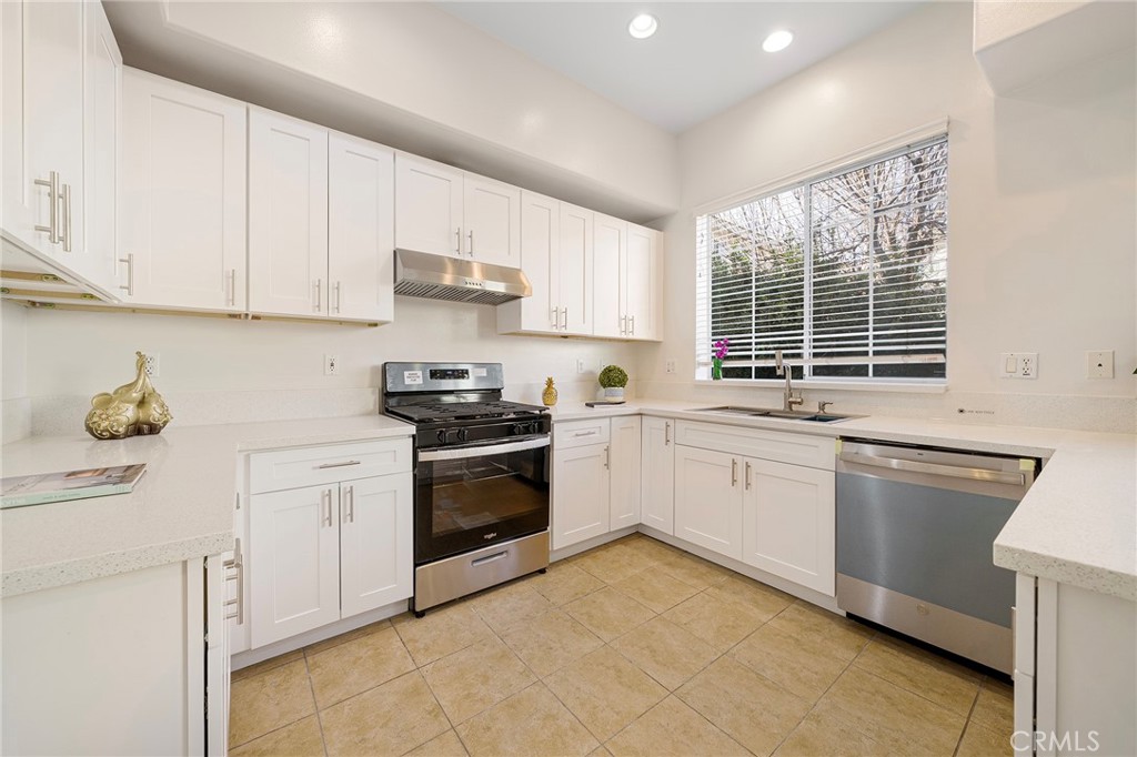 527 Fifth Avenue, Unit B Arcadia, CA 91006 - Photo 10 of 33 a kitchen with granite countertop white cabinets and white appliances