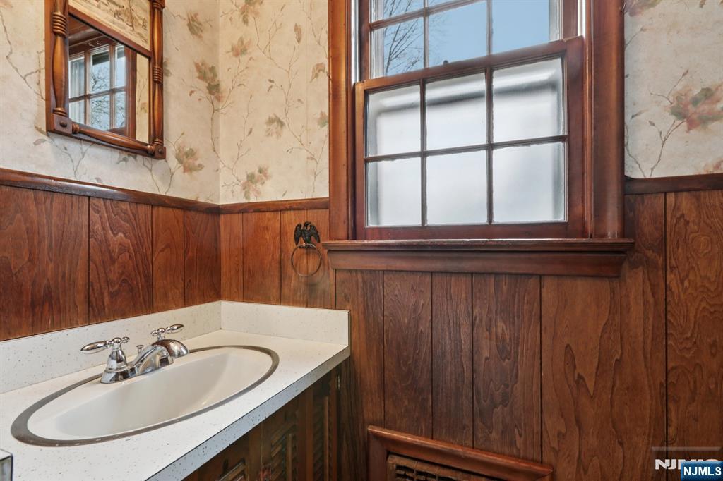 401 Walnut Street Nutley, NJ 07110 - Photo 11 of 25 a bathroom with a sink and a mirror