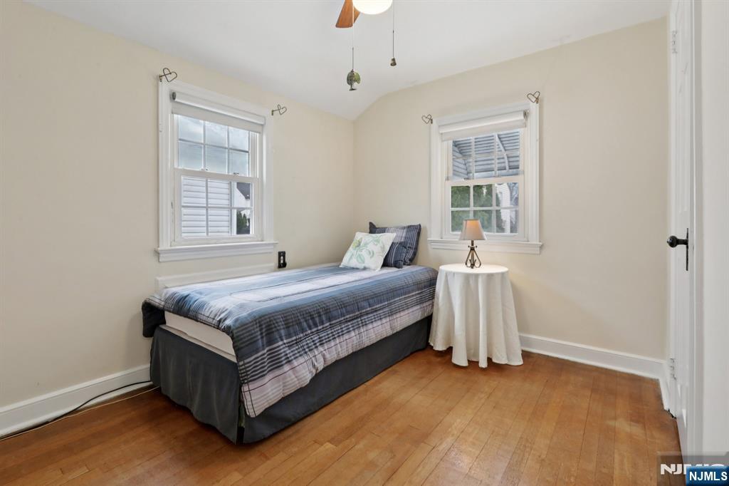 401 Walnut Street Nutley, NJ 07110 - Photo 13 of 25 a spacious bedroom with a bed and a window