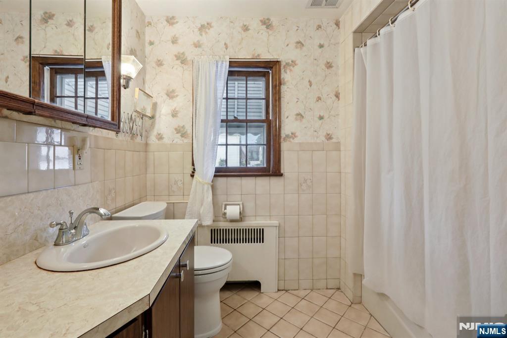 401 Walnut Street Nutley, NJ 07110 - Photo 14 of 25 a bathroom with a sink a toilet and shower