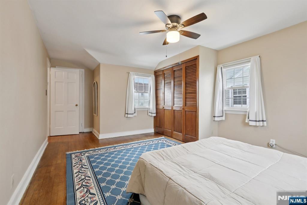 401 Walnut Street Nutley, NJ 07110 - Photo 16 of 25 a bedroom with a large bed dresser and a window