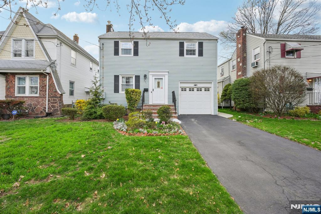 401 Walnut Street Nutley, NJ 07110 - Photo 19 of 25 a front view of a house with a garden and yard