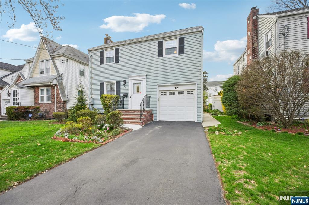 401 Walnut Street Nutley, NJ 07110 - Photo 20 of 25 a front view of a house with a yard and porch