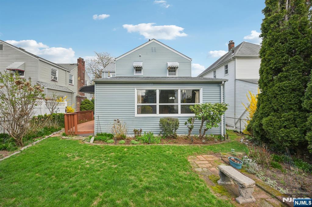 401 Walnut Street Nutley, NJ 07110 - Photo 24 of 25 a front view of a house with a yard and outdoor seating