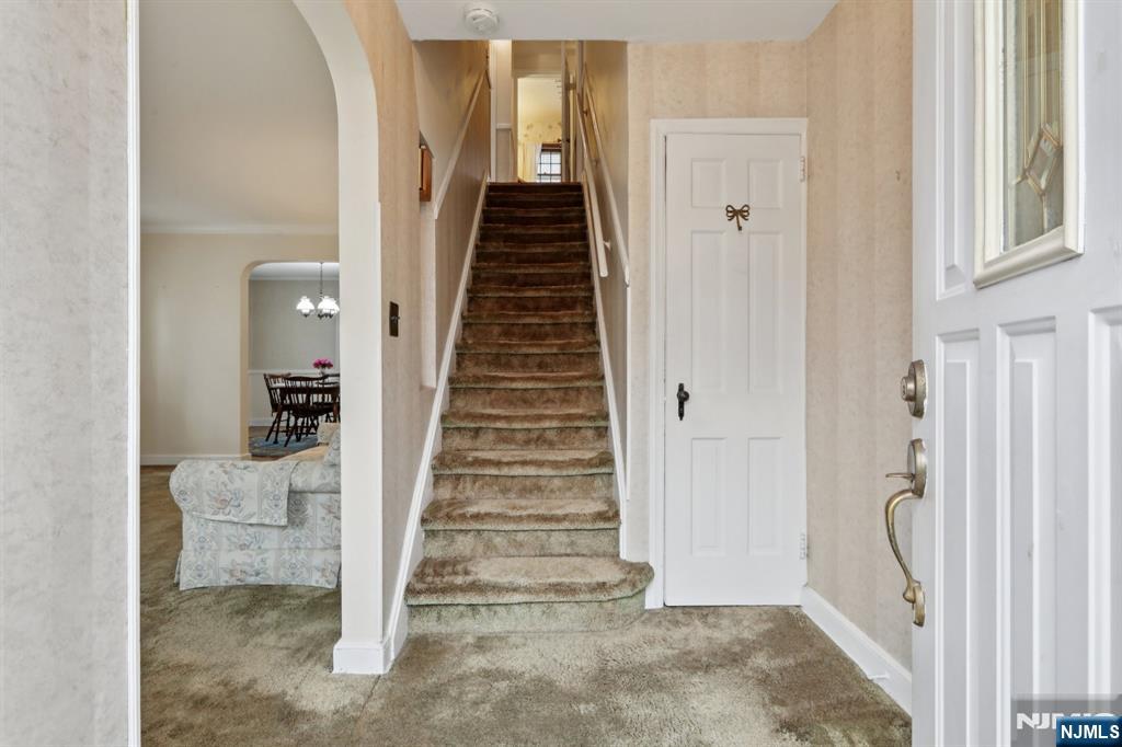 401 Walnut Street Nutley, NJ 07110 - Photo 3 of 25 a view of a hallway with entryway wooden floor and stairs