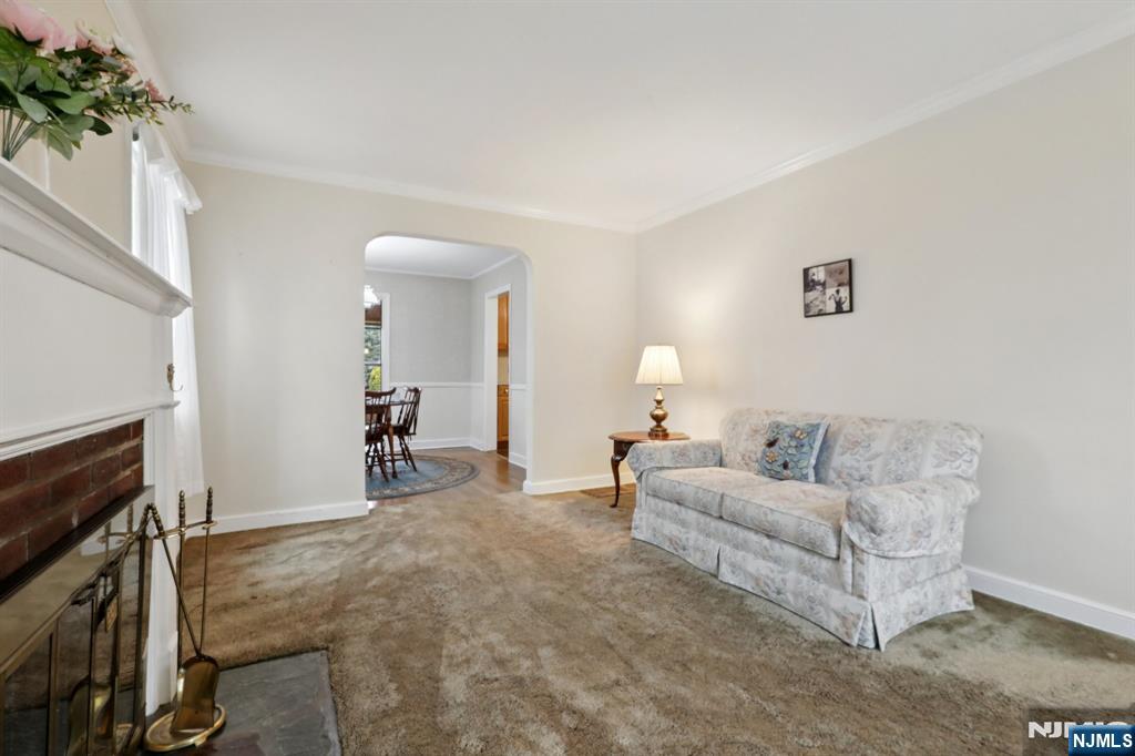 401 Walnut Street Nutley, NJ 07110 - Photo 5 of 25 a living room with furniture a fireplace and a potted plant