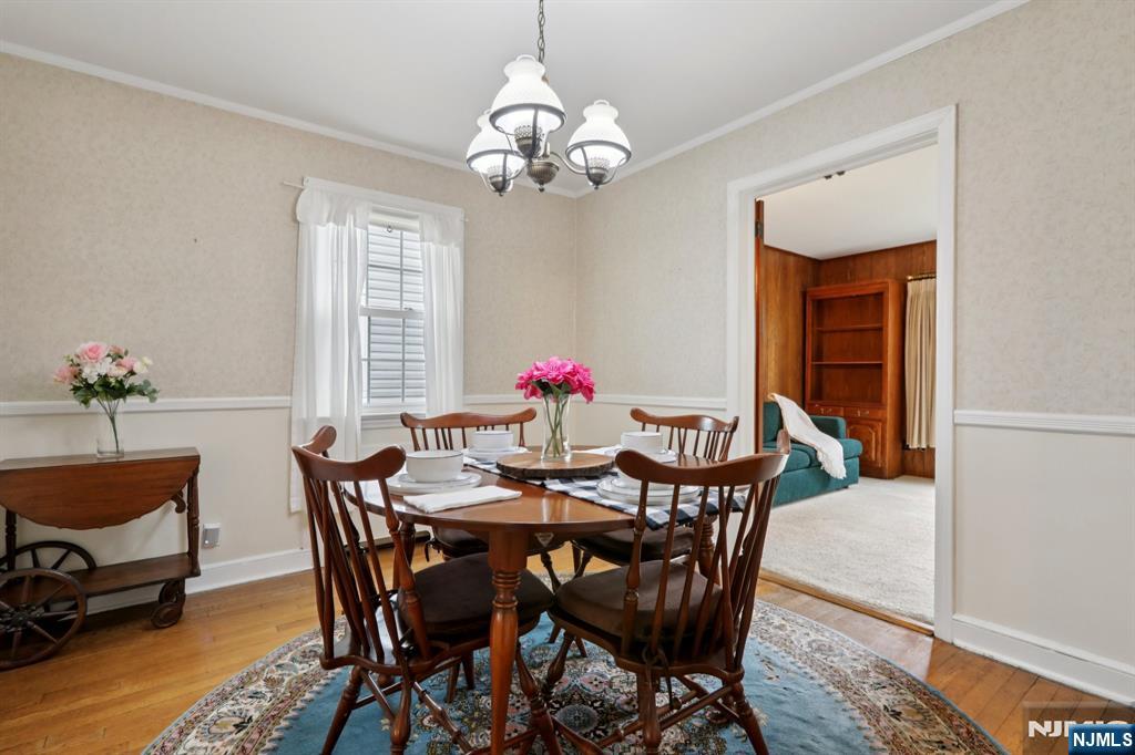 401 Walnut Street Nutley, NJ 07110 - Photo 6 of 25 a dining room with furniture potted plants and wooden floor