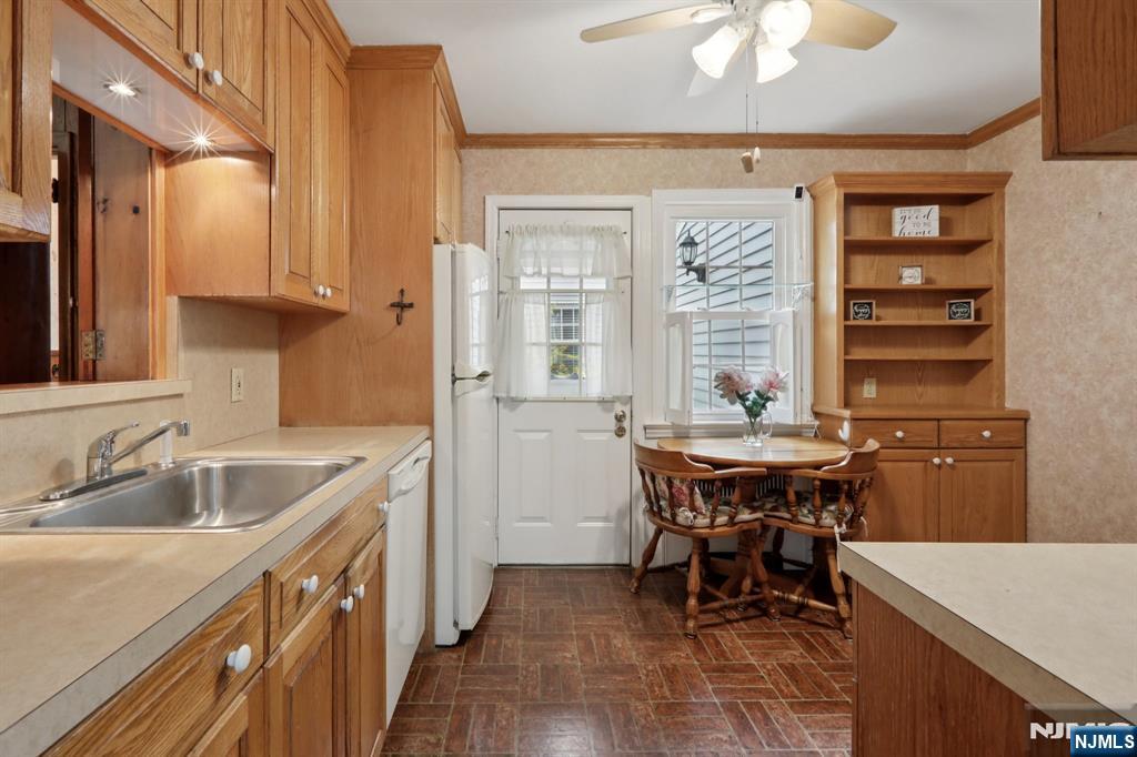 401 Walnut Street Nutley, NJ 07110 - Photo 7 of 25 a kitchen with a sink cabinets and window