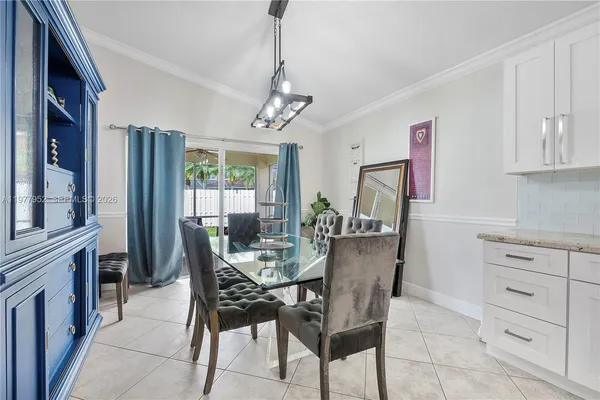 a dining room with furniture and window