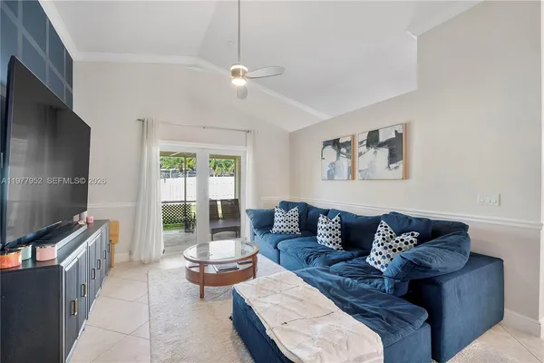 a living room with furniture and a flat screen tv