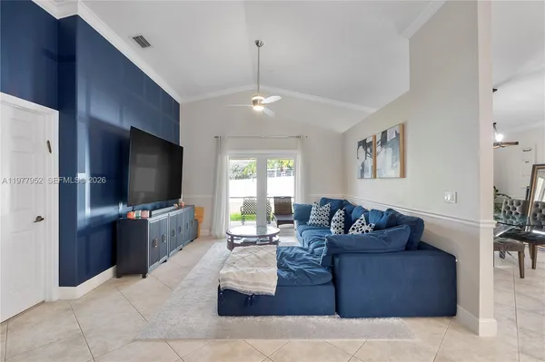 a living room with furniture and a flat screen tv
