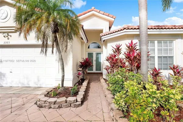 a front view of a house with a garden