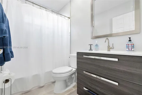 a bathroom with a sink a toilet and vanity