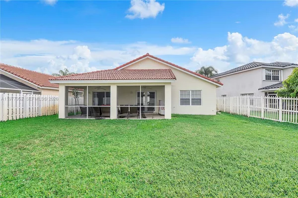 a view of a house with a backyard