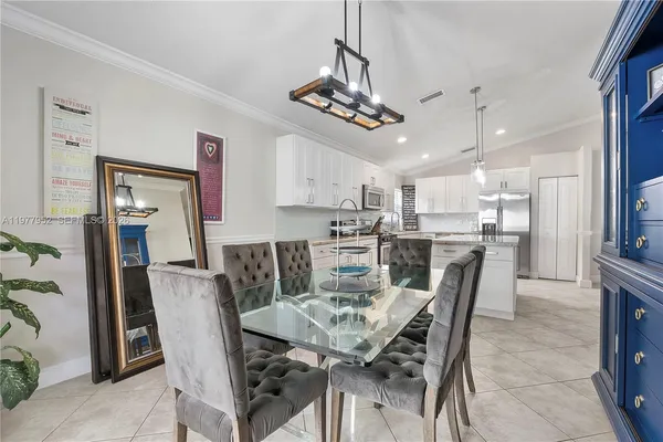 a view of a dining room with furniture and a chandelier
