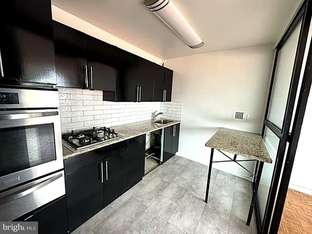 a kitchen with a stove and a refrigerator