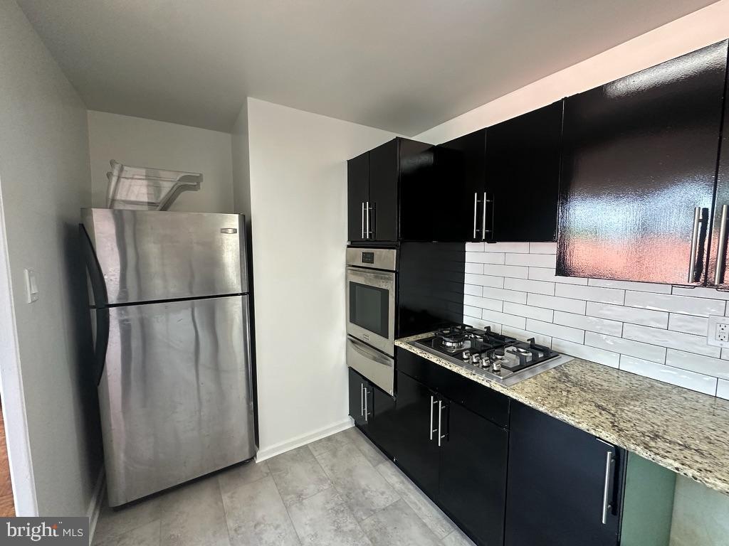 1401 Pennsylvania Avenue, Unit 612 Wilmington, DE 19806 - Photo 15 of 37 a kitchen with stainless steel appliances granite countertop a refrigerator and a stove top oven