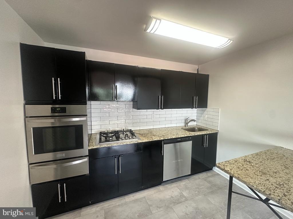 1401 Pennsylvania Avenue, Unit 612 Wilmington, DE 19806 - Photo 17 of 37 a kitchen with stainless steel appliances granite countertop a sink and a stove
