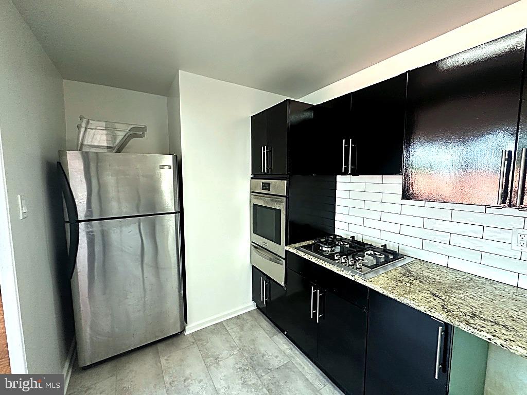 1401 Pennsylvania Avenue, Unit 612 Wilmington, DE 19806 - Photo 18 of 37 a kitchen with stainless steel appliances granite countertop a refrigerator and a stove top oven