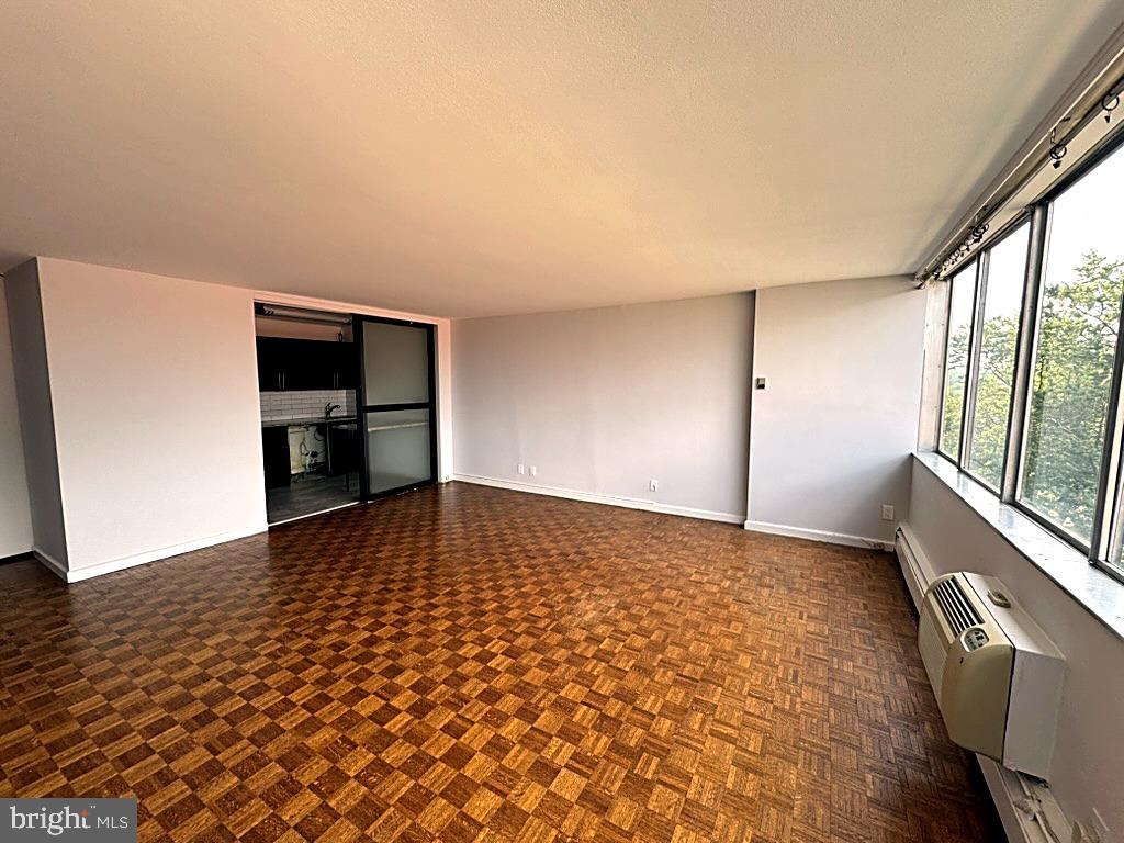 1401 Pennsylvania Avenue, Unit 612 Wilmington, DE 19806 - Photo 5 of 37 wooden floor in an empty room with a window