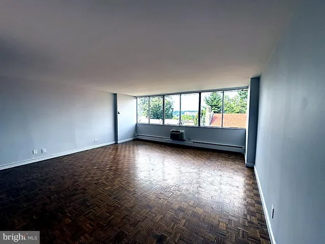 a view of room and window with hardwood floor
