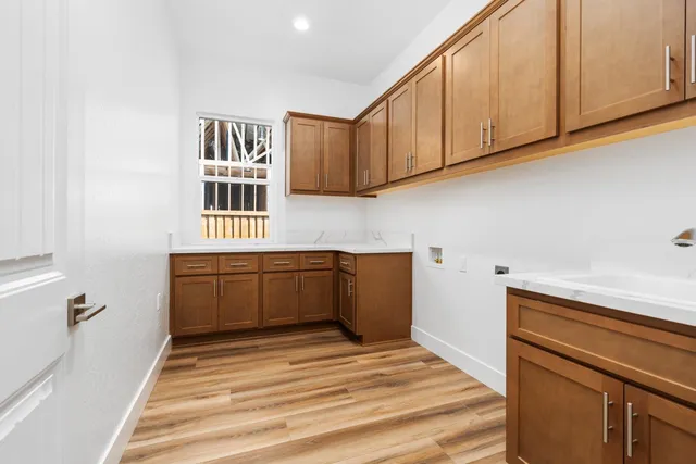 a view of a living room kitchen and a wooden floor