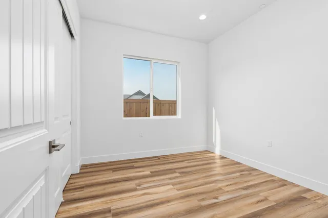a view of a room with wooden floor and entryway