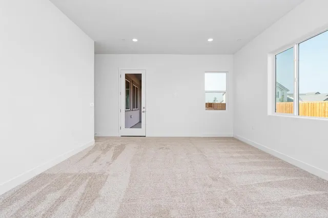 an empty room with windows and closet