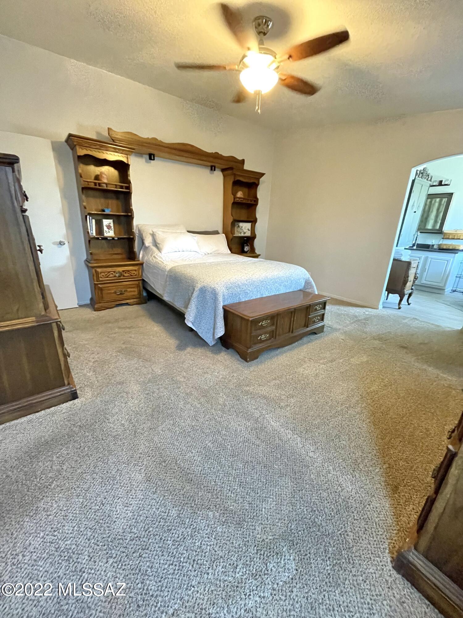 13643 East Bright Sky Loop Vail, AZ 85641 - Photo 17 of 22 a bedroom with a bed and a flat tv screen on dresser