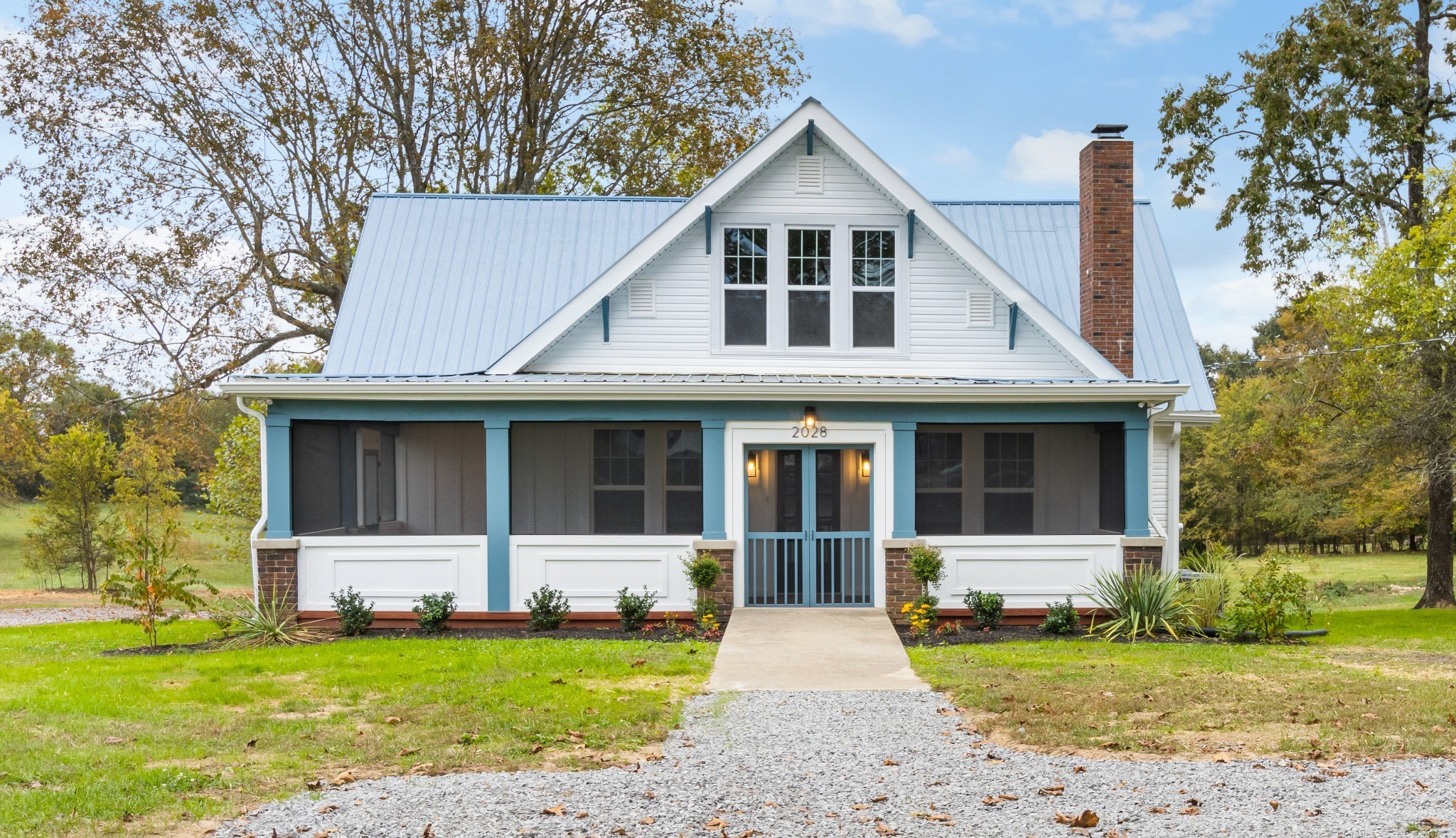 2028 Lock B Road North Clarksville, TN 37043 - Photo 4 of 47 a front view of a house with a garden and trees