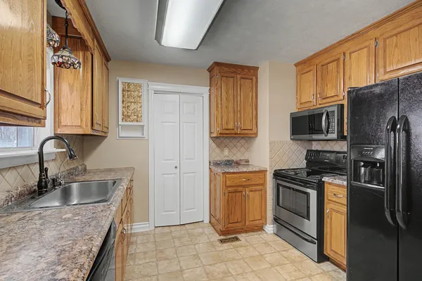 a kitchen with a sink stove and refrigerator