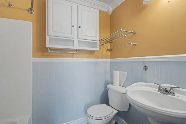 a white toilet sitting next to a bathroom sink