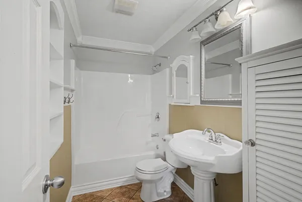 a bathroom with a sink toilet and a mirror