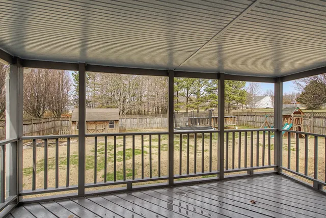 a view of a yard with wooden fence
