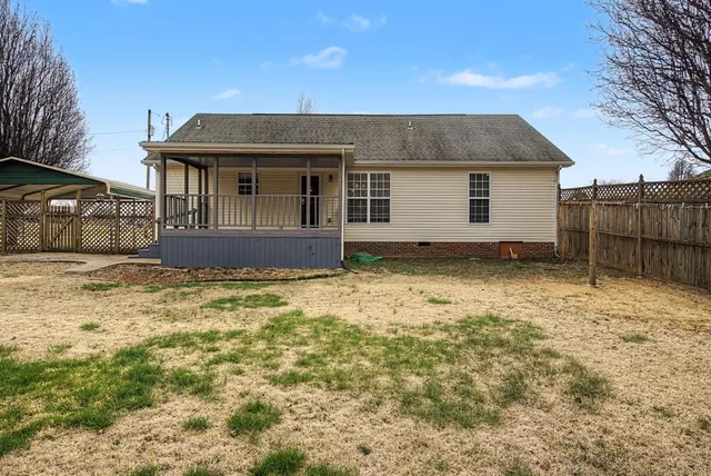 a front view of a house with a wooden fence