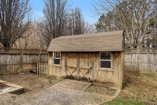 a front view of a house with a wooden fence