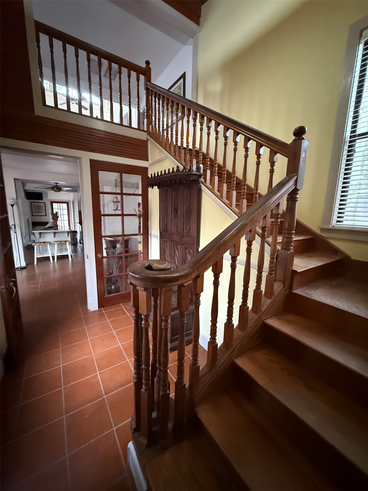 363 Porter Road Bastrop, TX 78602 - Photo 32 of 37 An elegant wooden staircase anchors this welcoming entry featuring rich tile and hardwood flooring.
