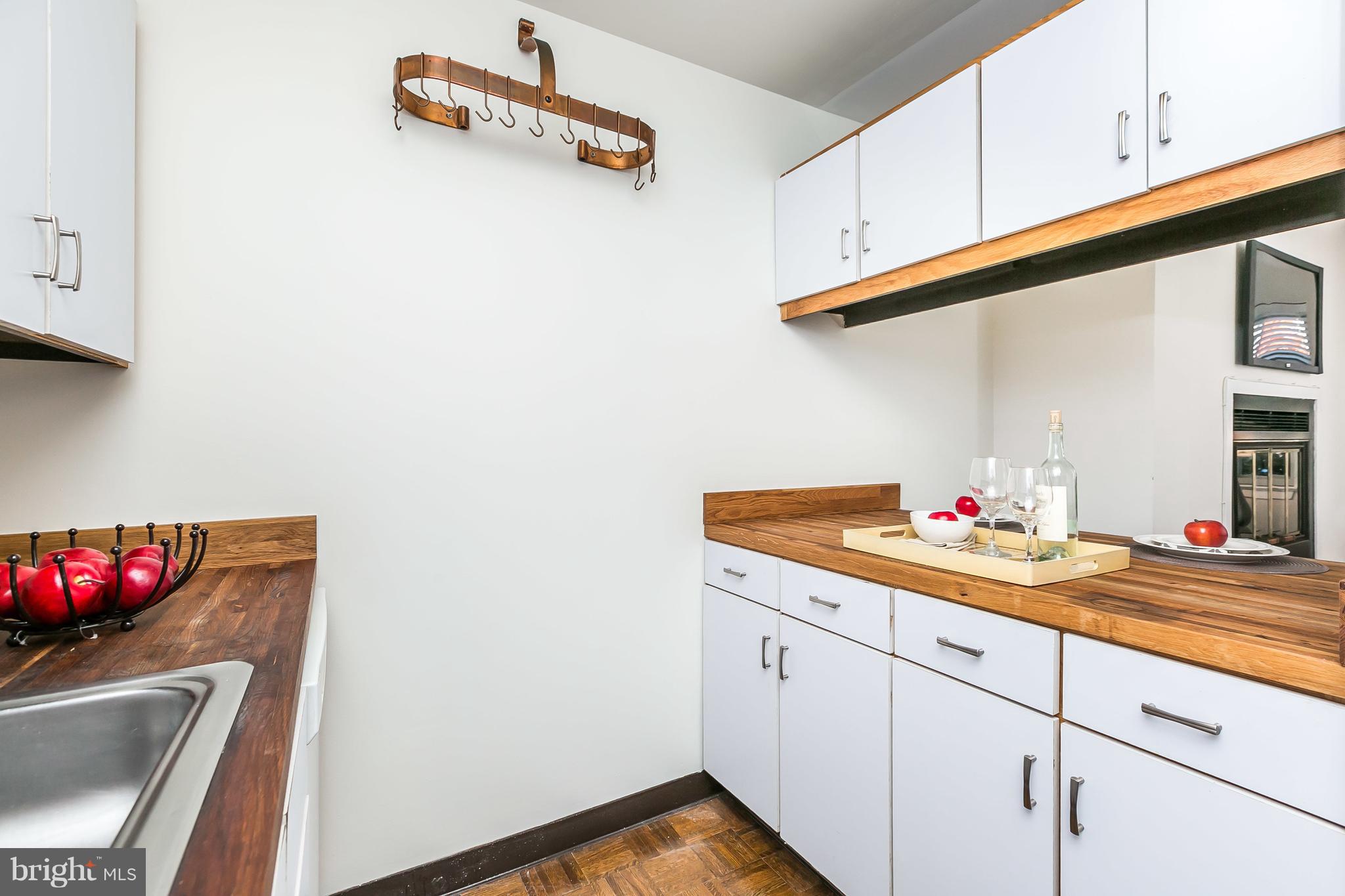 123 West Conway Street, Unit R58 Baltimore, MD 21201 - Photo 11 of 28 Copper pot rack and real butcher block counters.