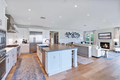 a kitchen with white cabinets and sink
