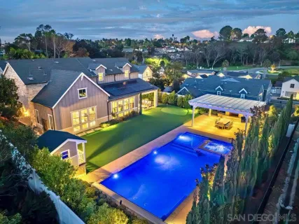 an aerial view of residential houses with outdoor space and swimming pool