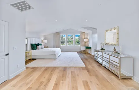 a bedroom with a large bed and a window