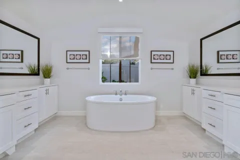 a bathroom with a sink mirror and a bathtub