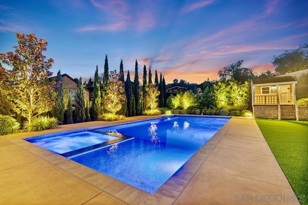 1259 Berryman Canyon Encinitas, CA 92024 - Photo 27 of 36 a view of swimming pool with outdoor seating and a buildings in the background
