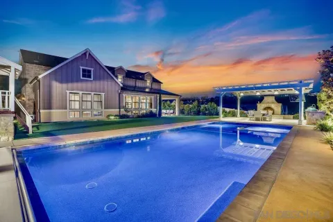 a view of a house with pool yard and balcony